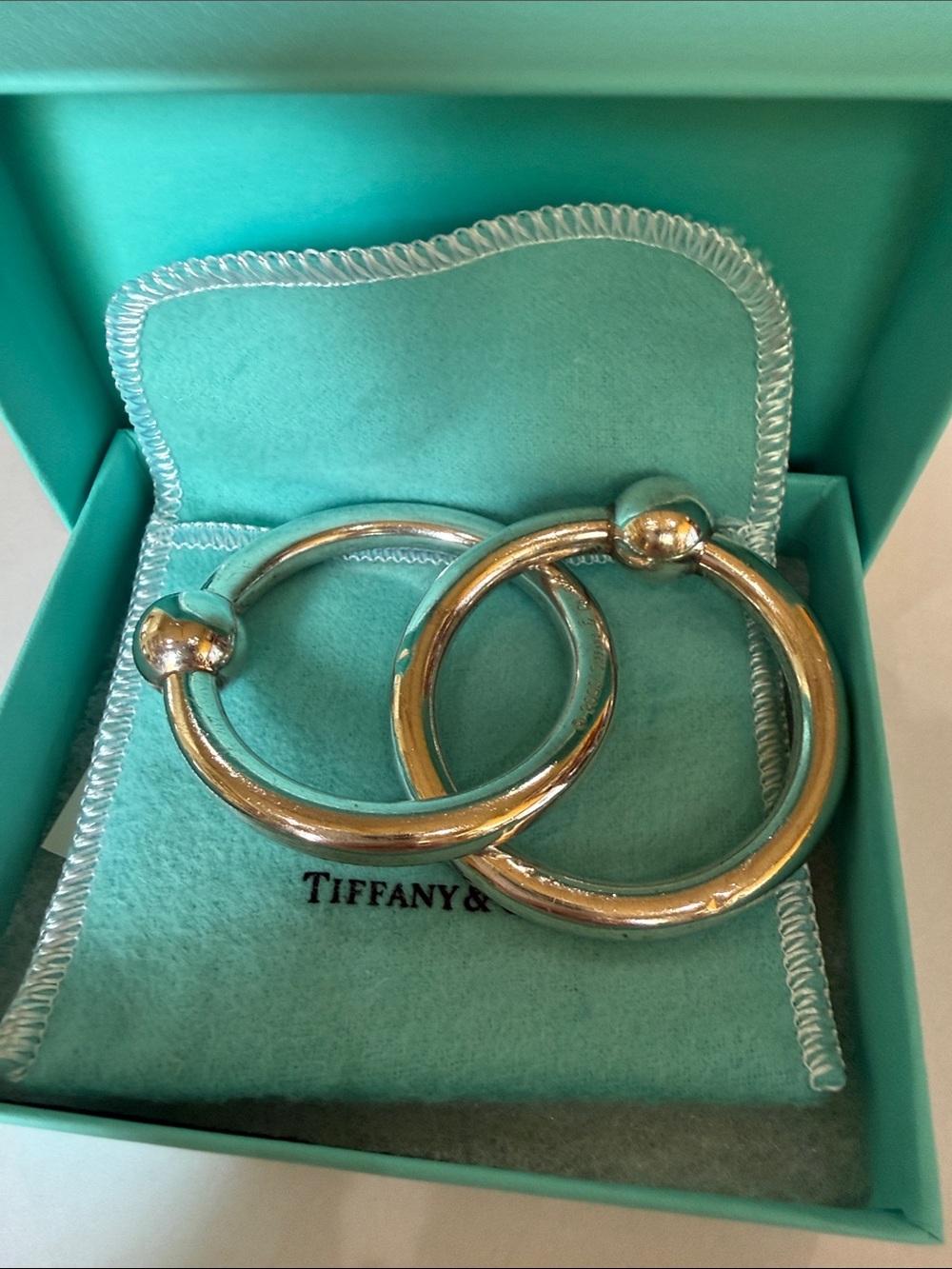 An Authentic Tiffany & Co. Sterling Silver Interlocking Double Ring Baby Rattle